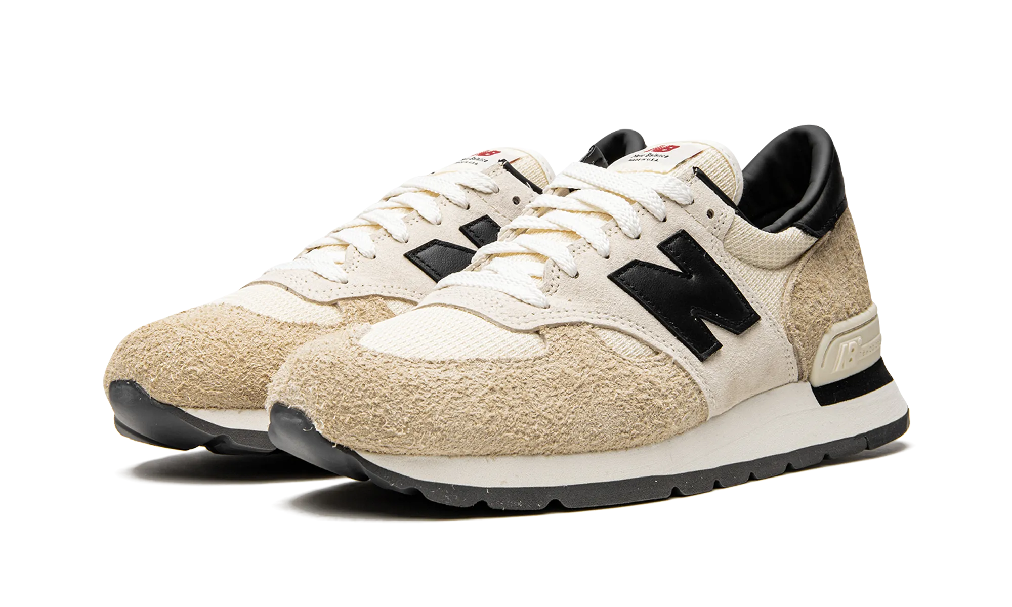 990 V1 "Teddy Santis - Macadamia Nut" running in a cross - country meet shoes Shock Reducing