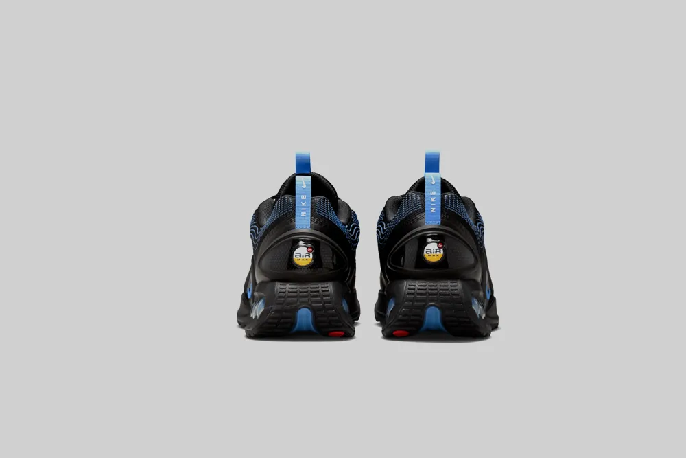 Nike Air Max Dn 'Black and University Blue' running in the park